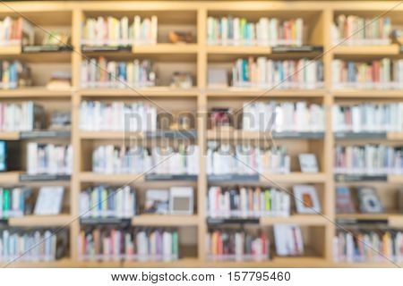 blurred bookshelf in library room for your background design - vintage color styles.