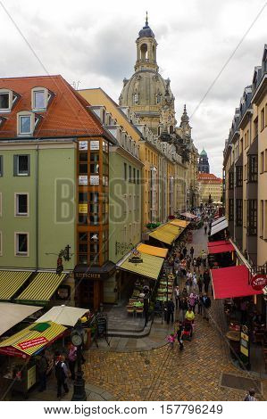 DRESDEN GERMANY - SEPTEMBER 21 2013: the Pedestrians in the Munzgasse alleyway. The historic cobblestone alley is lined with many of Dresdens most famous restaurants and cafes.
