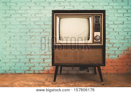 Retro old television in vintage wall pastel color background