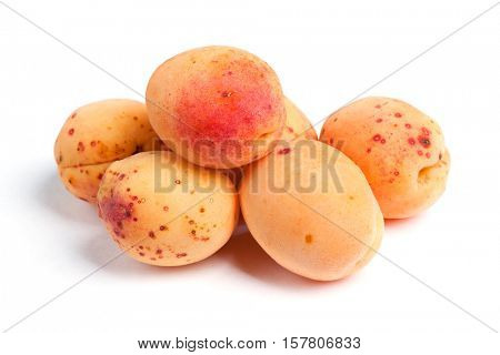 Real apricots isolated on white background