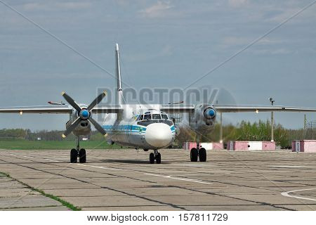 Vasilkov Ukraine - April 24 2012: Ukraine Air Force Antonov An-26 cargo plane is starting the engines before takeoff