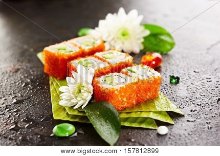 California Maki Sushi with Masago - Roll made of Crab Meat, Avocado, Cucumber, Japanese Mayonnaise inside. Masago (smelt roe) outside