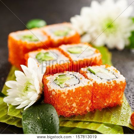 California Maki Sushi with Masago - Roll made of Crab Meat, Avocado, Cucumber, Japanese Mayonnaise inside. Masago (smelt roe) outside