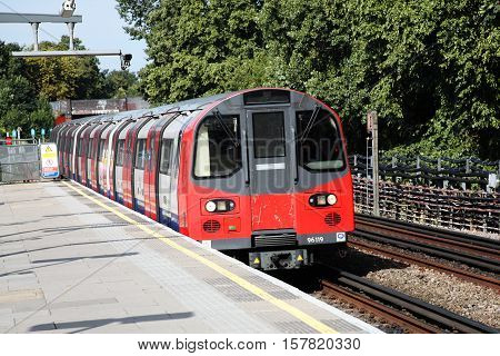 London, UK, August 19 2012: Underground tube train entering Kilburn Station on its route along the Jubilee Line