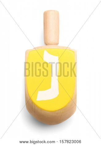 Wooden dreidel for Hanukkah on white background