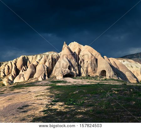Dramatic spring scene in Cappadocia. Red Rose valley under a storm in April. Cavusin village located district of Nevsehir Province in the Central Anatolia Region of Turkey Asia.
