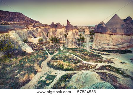 Fungous forms of sandstone in the canyon near Cavusin village Cappadocia Nevsehir Province in the Central Anatolia Region of Turkey Asia. Artistic style post processed photo. Retro style filtered.