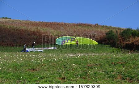 ROCCA PRIORA ITALY - NOVEMBER 1 2016: paragliding lesson paragliders set their wings