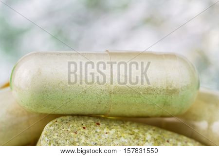 Mixed natural food supplement pills multivitamin and glucosamine capsules macro image