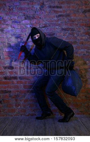 Theif near wall of building