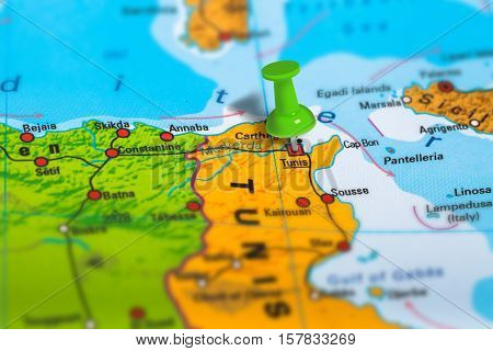 Tunis capital city in Tunisia pinned on colorful political map of Africa. Geopolitical school atlas. Tilt shift effect.