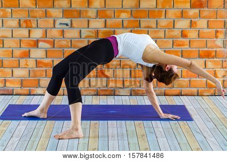 young woman stretching and getting ready for her yoga class