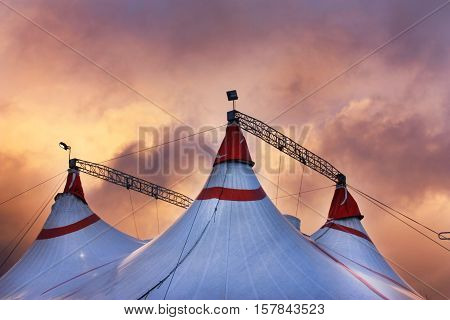 Circus tent under the dramatic sunset sky