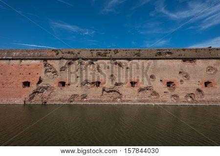 Damaged Wall and Moat at Fort Pulaski with blue sky