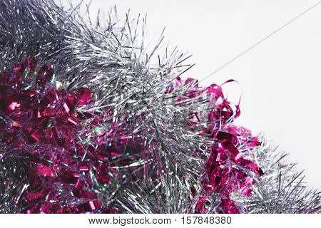 Photo by pink and silver tinsel. Diagonal.