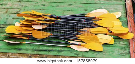 Yellow kayak paddles on the dock closeup