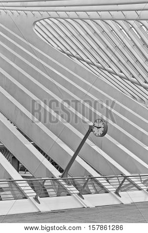 LIEGE BELGIUM - December 2014: Abstract view on the roof with station clock of the Liege-Guillemins railway station designed by Santiago Calatrava. Black and white photograph