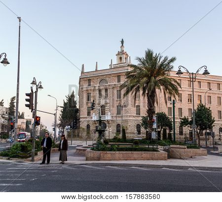JERUSALEM ISRAEL - FEBRUARY 26: The building of the Terra Sancta College on its roof is a statue of the Madonna on Paris Square in sunset light in Jerusalem Israel on February 26 2016