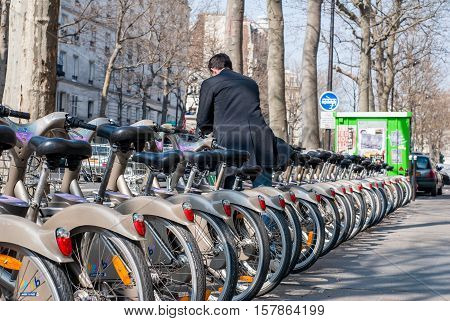 Paris, France - April 02, 2009: Young Man Depositing His Bike At The Velib Station Public Bicycle Re