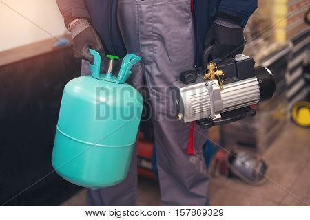 Air conditioning master preparing to install new air conditioner. removal of gases from the freon tubes