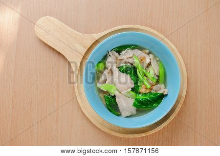 Noodles in thick gravy with pork and flower on the table