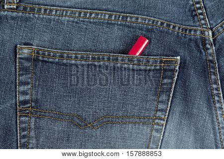 UMEA, SWEDEN ON DECEMBER 03, 2014. Illustration, a pair of blue jeans and a carpenter's pencil in a pocket on December 03, 2014 in Umea, Sweden. Well used pants, wooden red pencil. Illustrative editorial.