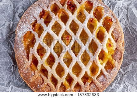 Home baked Lattice apple pie on crumpled paper.