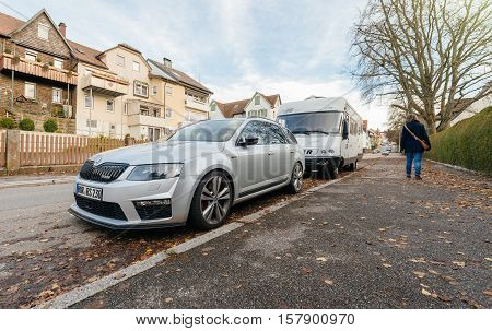 FREUDENSTADT GERMANY - NOV 20 2016: Sport racing Skoda V RS parked on the German street with german architecture in the background and pedestrian on the sidewalk