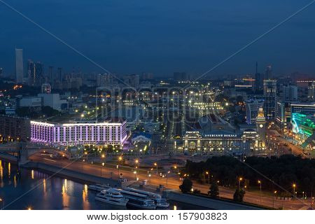 Kievsky railway station with illumination at night in Moscow, text - Kievsky railway station