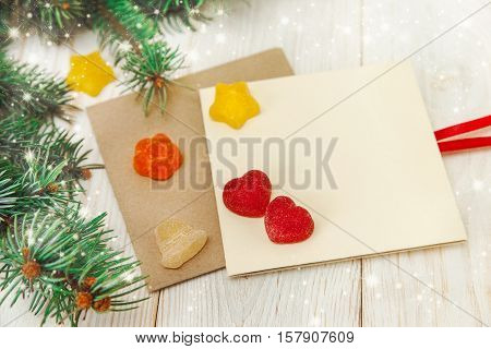 Christmas background. Tree branch jujube and empty cards. White wooden table.