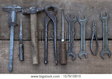 A collection of old rusty tools. Carpentry, hammer, knife, saw, scissor, worn