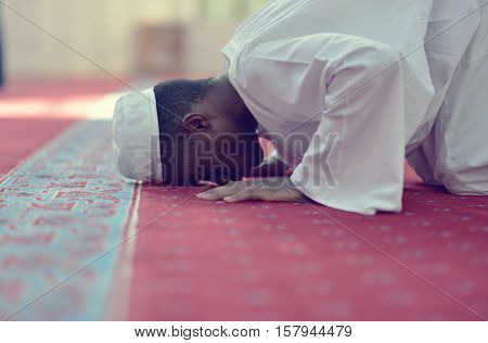 African Muslim Man Making Traditional Praying To God While Wearing A Traditional Cap Dishdasha