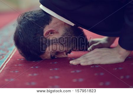 Handsome Younger Muslim Arabic man praying in mosque