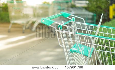 Shopping and mall concept - Close up shopping cart on car parking in mall with copyspace