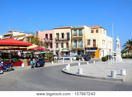 RETHYMNO, CRETE - SEPTEMBER 15, 2016 - Statue to the unknown soldier and pavement cafes in Agia Stratiota Square (Agnostou Square) Rethymno Crete Greece Europe, September 15, 2016.