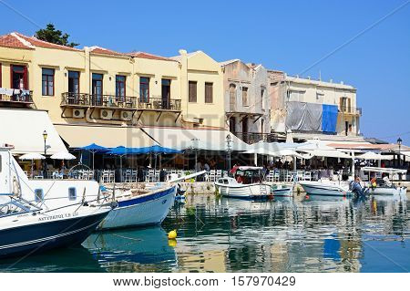 RETHYMNO, CRETE - SEPTEMBER 15, 2016 - View of boats and waterfront restaurants in the inner harbour Rethymno Crete Greece Europe, September 15, 2016.