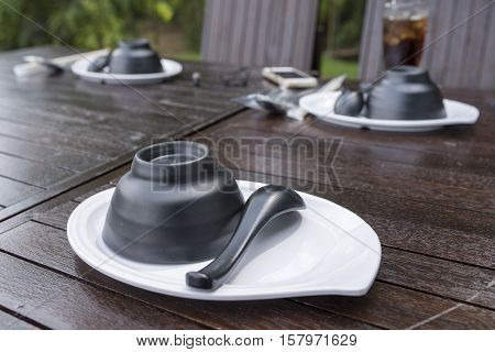 Black Cup and Black spoon on wood table
