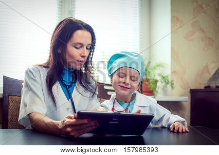 Two little girl doctor dressed with stethoscope