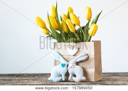Easter Background Yellow Tulips On Wooden Table, Rabbit, Eggs,nest Candy