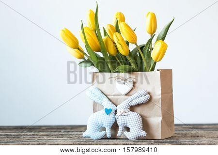 Easter Background Yellow Tulips On Wooden Table, Rabbit, Eggs,nest Candy