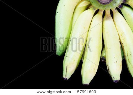 Cavendish bananas on black granite table background.