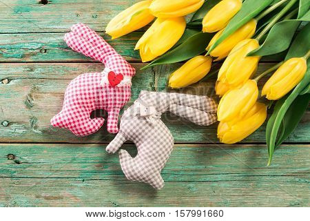 Easter Background Yellow Tulips On Wooden Table, Rabbit, Eggs,nest Candy