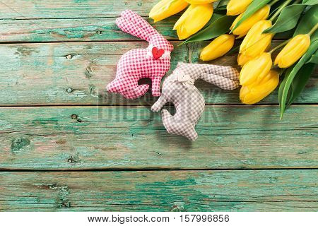 Easter Background Yellow Tulips On Wooden Table, Rabbit, Eggs,nest Candy