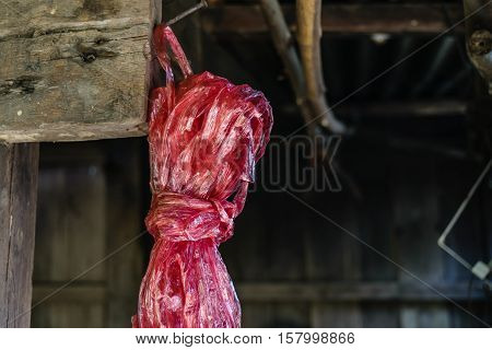 Red plastic rope rope on blur barn background