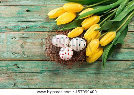 Easter Background Yellow Tulips On Wooden Table, Rabbit, Eggs,nest Candy