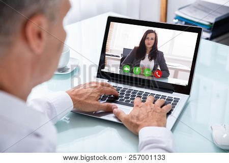 Businessman Videoconferencing With Colleague On Laptop