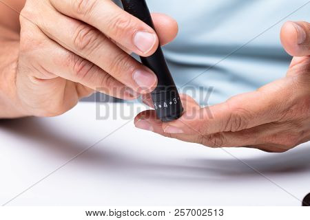 Man Testing High Blood Sugar With Glucometer