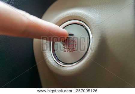 Hand Pushing A Push Start Button Of A Car / Automobile With Keyless Entry