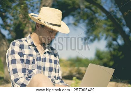 Young Male Travel Graphic Designer Freelancer Working With Lapop On The Beach