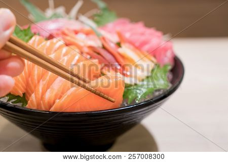 Mixed Sliced Fish Sashimi On Ice In Black Bowl. Sashimi Salmon Tuna Hamachi Prawn And Surf Calm Set,